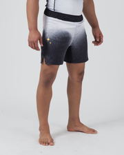 Kingz Galaxy Performance Series Shorts Black White - Full Body 3/4 Angled Front Right View Male Athlete Galaxy Gradient Gold Star Sparkle Graphics Left Panel Competition Cut Men's Grappling Shorts No-Gi BJJ