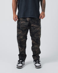 Kingz Casual Rip Stop Gi Pants - Camo - Front View Male Athlete Dark Camo Pattern Rip Stop Fabric Subtle Logo Right Thigh Relaxed Fit BJJ Gi Training Apparel [color:Dark/Camo]