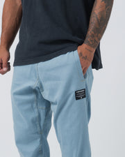 Kingz Casual Gi Pant Light Denim - Close-Up Side View Tattooed Male Light Denim Color Black Label Patch Relaxed Fit BJJ Gi Training Apparel [color:Light Denim]