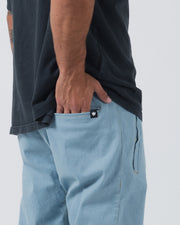 Kingz Casual Gi Pant Light Denim - Close-Up Side View Male Athlete Light Denim Fabric Black Crown Logo Back Pocket Stitching Detail BJJ Gi Training Apparel [color:Light Denim]