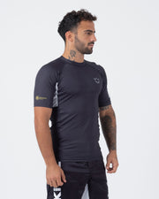 Kingz Ranked Performance V2 S/S Rashguard Dark Charcoal White - Full Body 3/4 Front Left Side View Male Athlete Short Sleeve Crown Logo Chest Gold KINGZ KIMONOS EST 2011 Crest Logo White Side Panel IBJJF Ranked BJJ Competition Guard