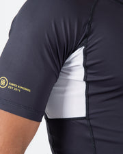 Kingz Ranked Performance V2 S/S Rashguard Dark Charcoal White - Close Up Side Detail Gold KINGZ KIMONOS EST 2011 Circular Crest Logo White Mesh Side Panel Dark Charcoal Body Performance Fit Mesh Ventilation IBJJF BJJ