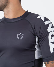 Kingz Ranked Performance V2 S/S Rashguard Dark Charcoal White - Close Up Chest Logo Detail White Outline Crown Logo Chest KINGZ Bold White Right Sleeve Panel Text Dark Charcoal Body Dark Collar White Mesh Panel BJJ IBJJF Performance