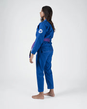 Kingz Classic 3.0 Women's BJJ Gi Blue - Full Body Side Profile View Female Athlete Purple Belt Crown Badge Logo Women's Slim Cut