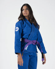 Kingz Classic 3.0 Women's BJJ Gi Blue - Upper Body Angled Front View Female Athlete Purple Belt Crown Badge Logo Chest Close Up
