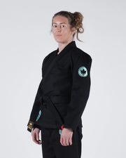 Kingz Classic 3.0 Women's BJJ Gi Black - 3/4 Angled Upper Body View Female Athlete Black Belt Teal Crown Badge Logo Sleeve