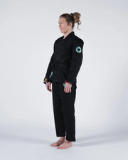Kingz Classic 3.0 Women's BJJ Gi Black - Full Body Side Profile View Female Athlete Black Belt Teal Crown Badge Logo Women's