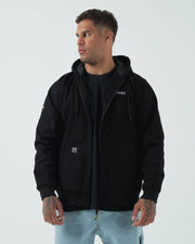 Kingz Canvas Jacket Black - Front View Male Model Black Hoodie Jacket KINGZ Chest Logo Patch Pocket Ribbed Cuffs Streetwear Casual Apparel [color:Black]