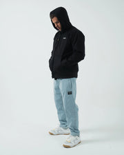 Kingz Canvas Jacket Black - Full Body Side View Male Model Hooded Black Jacket Subtle KINGZ Chest Logo Relaxed Fit Streetwear [color:Black]