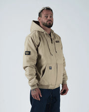 Kingz Canvas Jacket Tan - Three Quarter View Male Model Hooded Design KINGZ Chest Patch Crown Badge Left Sleeve Ribbed Cuffs and Hem Streetwear Casual Apparel [color:Tan]