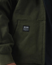 Kingz Canvas Jacket Military Green - Close-Up Detail View Pocket Area Kingz Logo Patch Left Side Ribbed Cuff Durable Fabric Streetwear [color:Military Green]