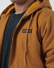 Kingz Canvas Jacket Desert - Close-Up Front View Male Model Chest KINGZ Text Patch Left Chest Tan Hood Lining Streetwear Casual Outerwear [color:Desert]
