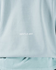 Sea foam green BJJ hoodie back detail closeup showing Gentle Art rear print on soft fleece fabric