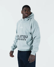 Sea foam green BJJ hoodie front three-quarter view on adult male model with bold Jiu Jitsu Squad print