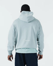 Sea foam green BJJ hoodie back view on adult male model displaying Gentle Art rear print and hood down