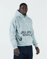Sea foam green BJJ hoodie front standing view on adult male model with Jiu Jitsu Squad print and sleeve logos