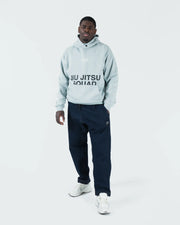 Sea foam green BJJ hoodie full length walking lifestyle shot with adult male model in casual streetwear