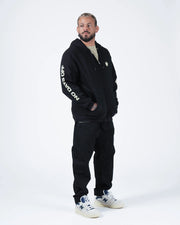 Kingz No Days Off Zip Up Hoodie - Full Body Casual Pose - Hand in Pocket Streetwear Look - Black - BJJ Streetwear Hoodie