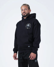 Black BJJ hoodie side profile view on adult male model showing rose chest graphic and heavyweight drape