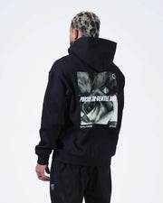 Black BJJ hoodie back three-quarter view on adult male model displaying rose photo graphic and hood