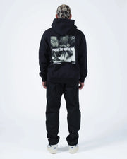 Black BJJ hoodie full length straight back view on adult male model with centered rose photo back print