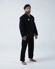 Kingz Kore V2 BJJ Gi Black - 3/4 Angled Front View Male Athlete Wearing Complete Black Gi Set Woven Label Chest Patch Black Belt