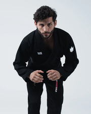 Kingz Kore V2 BJJ Gi Black - Upper Body Front View Second Athlete Wearing Black Gi Jacket Crown Logo Chest Patch Hands Forward