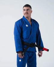 Kingz Kore V2 BJJ Gi Blue - 3/4 Standing Pose Athlete Wearing Full Blue Gi Set Lifestyle