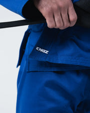 Kingz Kore V2 BJJ Gi Blue - Close Up Waistband Detail KINGZ Branding Embroidered Text Hand Gripping Black Belt