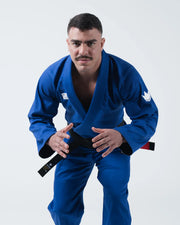 Kingz Kore V2 BJJ Gi Blue - Upper Body Front View Athlete Ready Stance Wearing Blue Kimono Crown Logo Chest Patch Black Belt