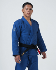 Kingz Balistico 4.0 BJJ Gi Blue three-quarter front view showing black belt with gold Kingz label tab