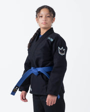 Kingz Nano 3.0 Women's BJJ Gi Black - Upper Body 3/4 Angled View Female Athlete Blue Belt NANO Text Crown Logo Sleeve