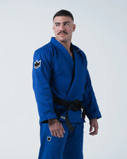 Kingz Nano 3.0 BJJ Gi Blue three-quarter standing view showing black belt and crown shoulder patch