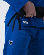 Kingz Nano 3.0 BJJ Gi Blue hip closeup showing hand on black belt Kingz label and pant crown logo