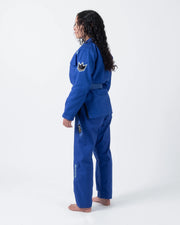 Kingz Nano 3.0 Women's BJJ Gi Blue - Full Body 3/4 Back View Female Athlete Blue Belt Crown Logo NANO Text Pants Leg
