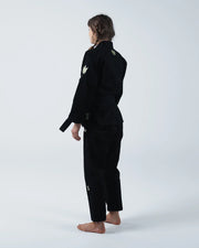 Kingz The ONE V2 Women's Jiu Jitsu Gi - Black - Back View Female Athlete Black Gi Gold Crown Shoulder Logos Tailored Fit BJJ Training Gi [color:Black]