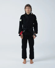 Kingz The ONE V2 Women's Jiu Jitsu Gi Black - Full Body Front View Female Athlete Black Gi Crown Logo Sleeves Red Black Belt Minimalist Design BJJ Gi Training Apparel [color:Black]