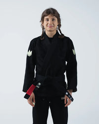 Kingz The ONE V2 Women's Jiu Jitsu Gi - Black - Full Body Front View Female Athlete Black Gi Crown Logo Sleeves Red and Black Belt Patch Modern Fit Durable Fabric BJJ Gi Training [color:Black]