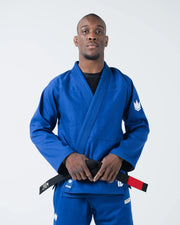 Kingz The ONE V2 BJJ Gi Blue front view of male athlete holding black red bar belt at the waist
