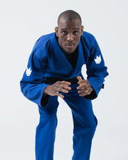 Kingz The ONE V2 BJJ Gi Blue front competition stance showing male athlete crouched with crown patches