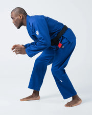 Kingz The ONE V2 BJJ Gi Blue side profile of male athlete in competition ready fighting stance