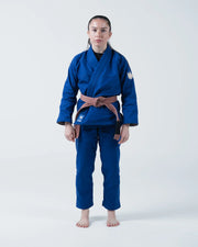 Kingz The ONE V2 Women's Jiu Jitsu Gi Blue - Full Body Front View Female Athlete Solid Blue Gi Crown Badge Left Arm Patch Contrast Stitching Durable Fabric BJJ Gi Training [color:Blue]
