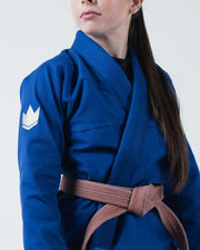 Kingz The ONE V2 Women's Jiu Jitsu Gi - Blue - Close-Up Front View Female Athlete Blue Gi White Crown Badge Left Arm Brown Belt Contrast Stitching BJJ Gi Training [color:Blue]