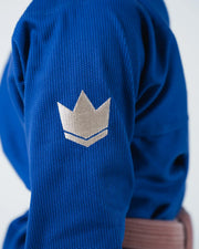 Kingz The ONE V2 Women's Jiu Jitsu Gi Blue - Close-Up Detail View Sleeve Gold Crown Badge Textured Fabric Deep Blue Color BJJ Gi Training Apparel [color:Blue]