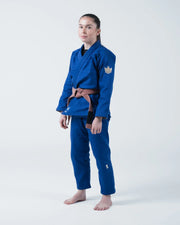 Kingz The ONE V2 Women's Jiu Jitsu Gi - Blue - Full Body Front View Female Athlete Blue Gi Crown Badge Left Arm Embroidered Logo Pants Lightweight Durable Design BJJ Gi Training [color:Blue]