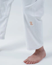 Kingz The ONE V2 Women's Jiu Jitsu Gi White - Close-Up Detail View Lower Leg Embroidered Logo Minimalist Design White Fabric Premium Stitching BJJ Gi Training Apparel [color:White]