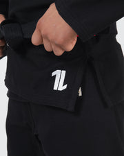 Kingz The ONE V2 BJJ Gi Black jacket skirt closeup showing white number one logo and crown embroidery