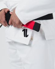 Kingz The ONE V2 BJJ Gi White skirt closeup showing number one logo hand and black red bar belt