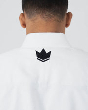 Kingz The ONE V2 BJJ Gi White upper back closeup showing black crown logo below rubber collar