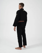 Kingz The ONE V2 LE BJJ Gi Black Green standing front view showing green pant logo and accent trim